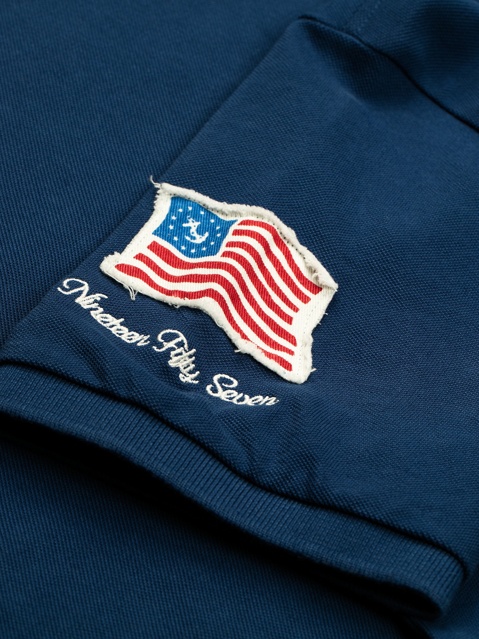 Polo in piquet con patch bluette